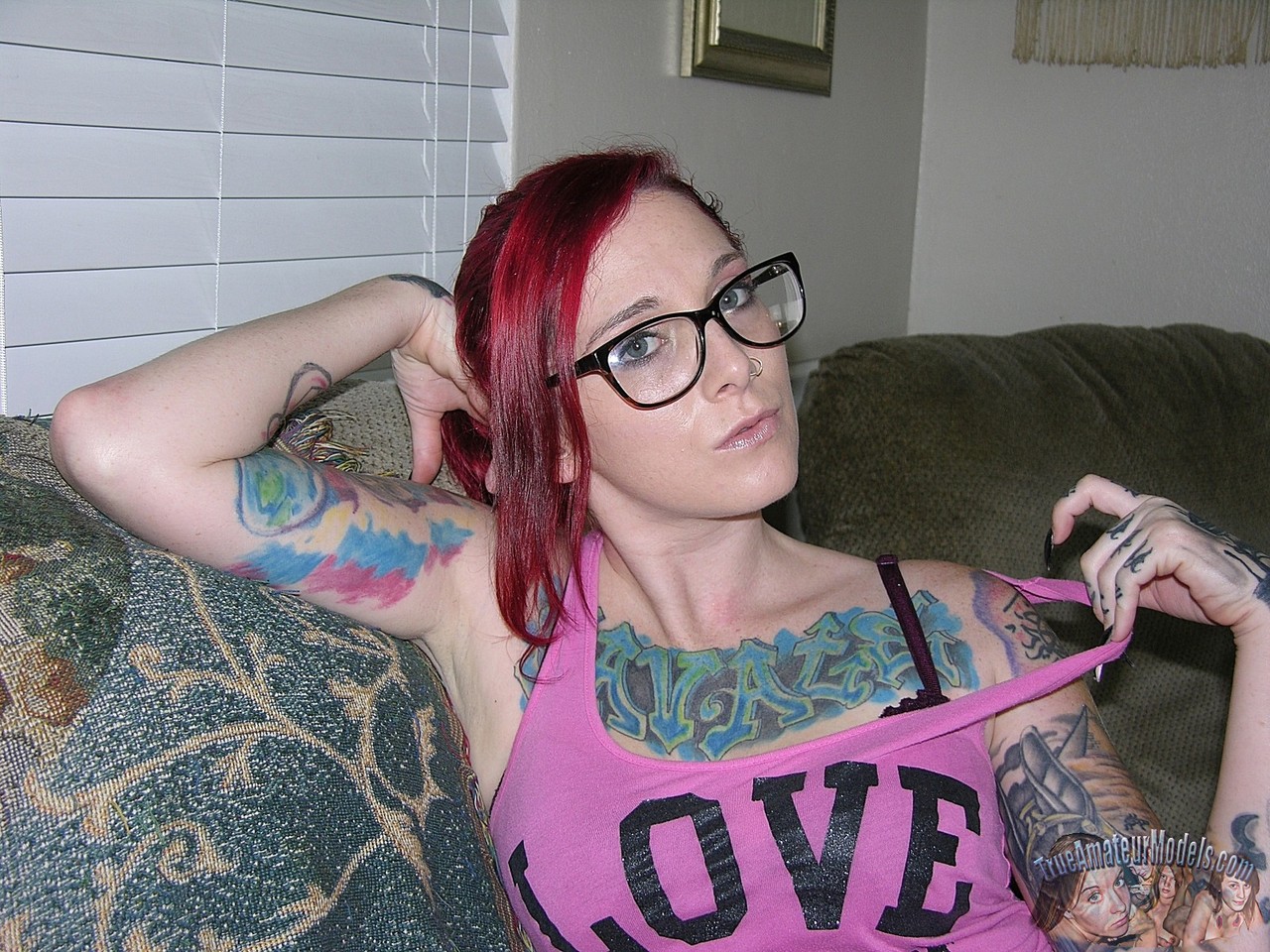 Tattooed redhead Lola takes off her glasses and clothes for her first nudes porno foto #426299010