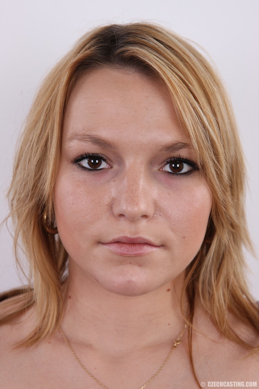 Strawberry blonde amateur Erika gets nude and takes a seat on the stool.