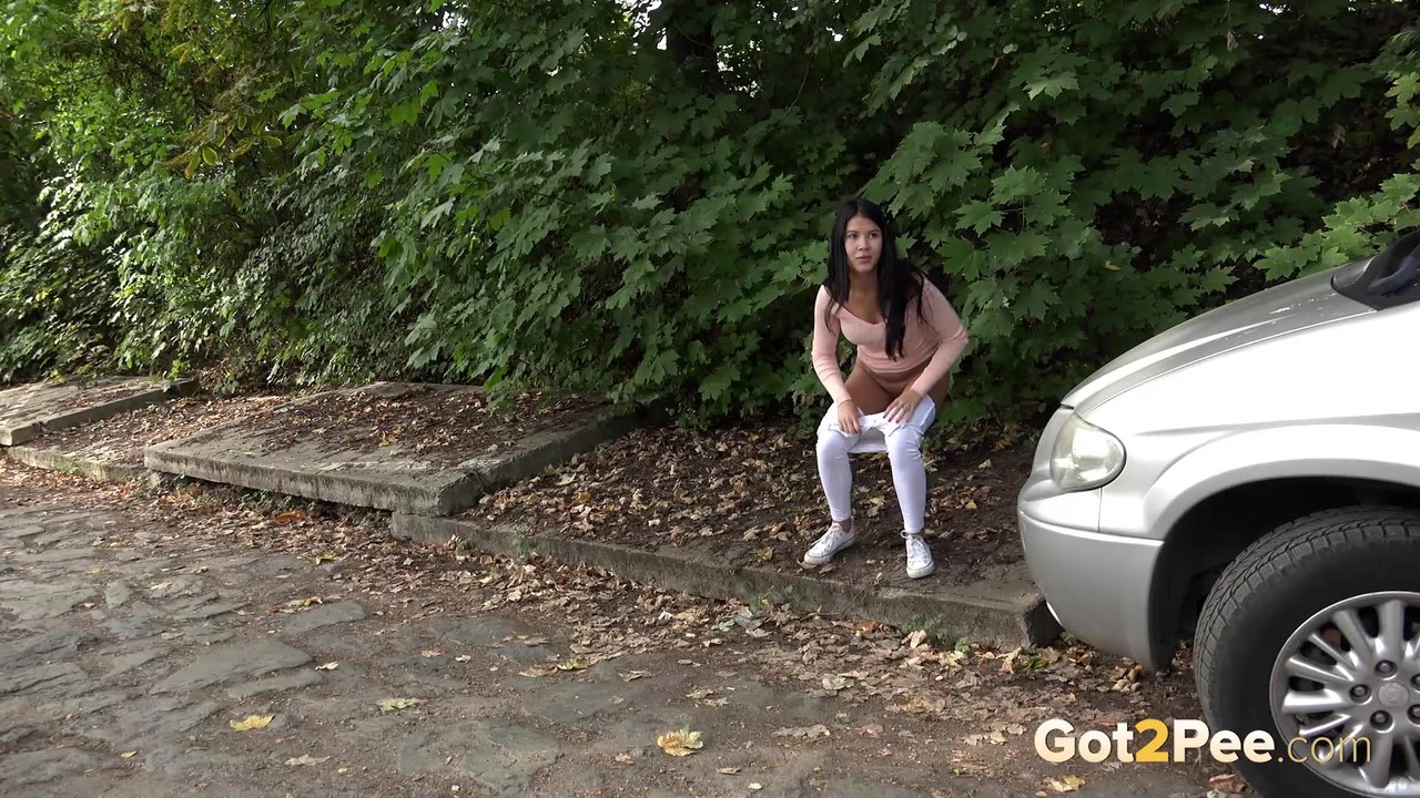 Dark haired girl Dee pulls down her white leggings for quick pee behind bushes porn photo #428754126