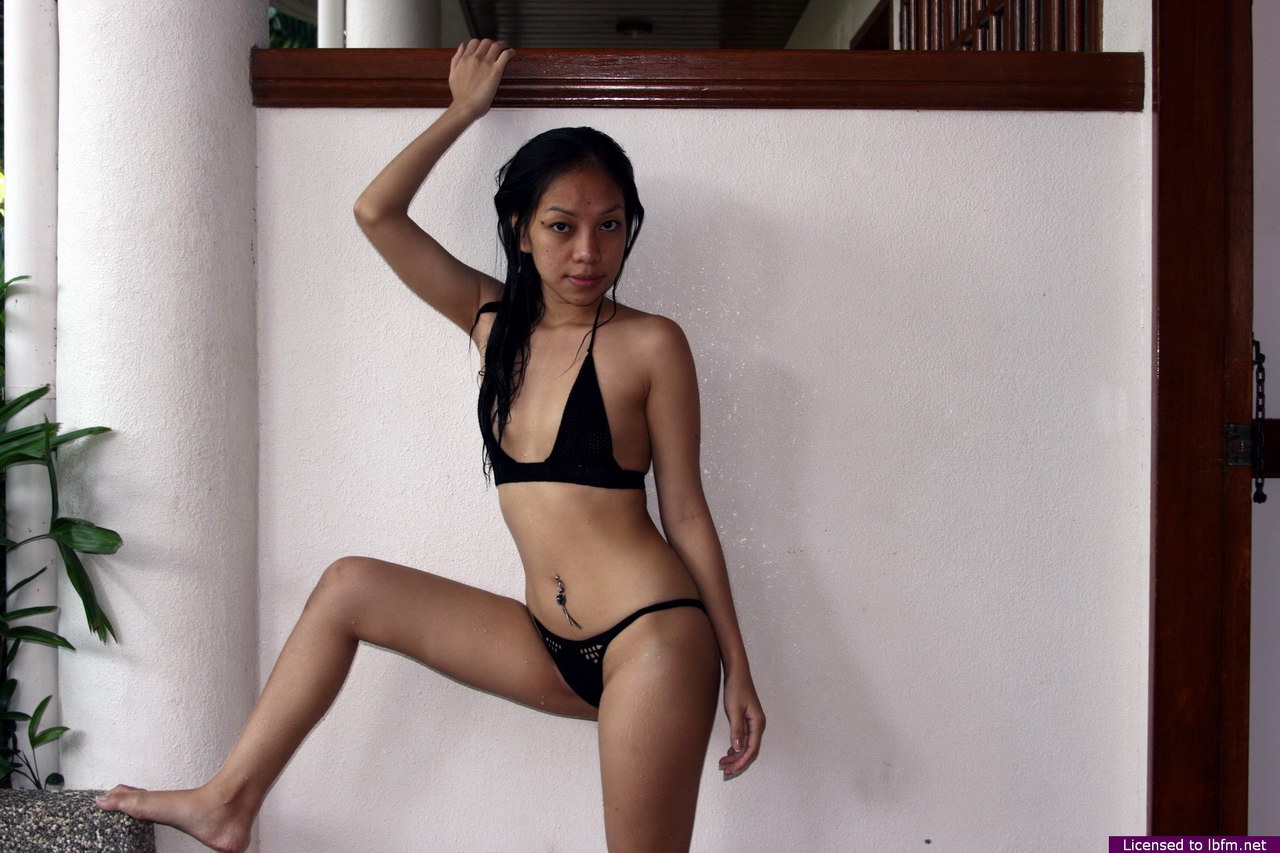 Petite Asian girl divests herself of a black bikini for her first nude poses porn photo #425623870