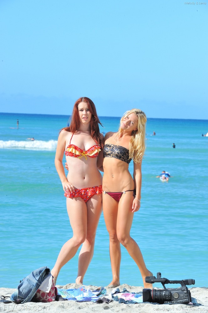 Lesbian lovers kiss at the beach prior to removing their bikinis porno foto #428107828