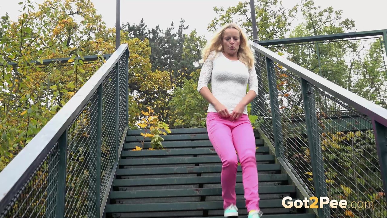 Blonde Victoria Pure pulling down her tight pants to pee on the bleachers foto porno #428771275