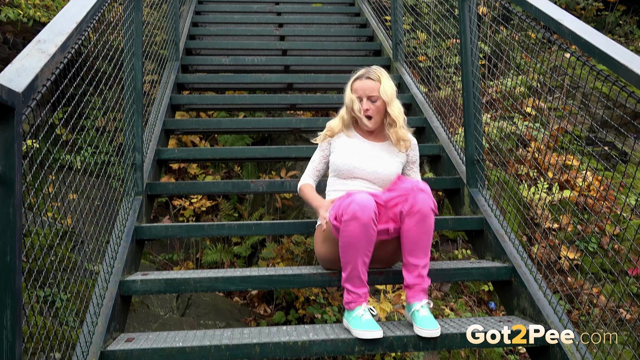 Blonde Victoria Pure pulling down her tight pants to pee on the bleachers foto porno #428771277