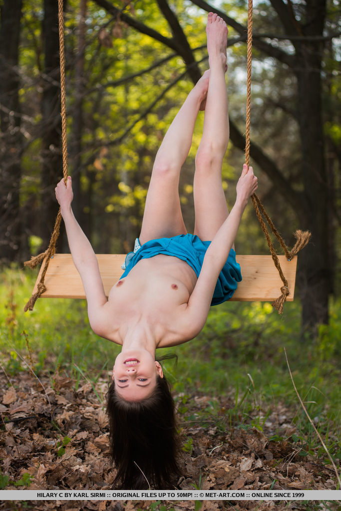 Young brunette Hilary C is encouraged to get naked on swing set in forest photo porno #425338933