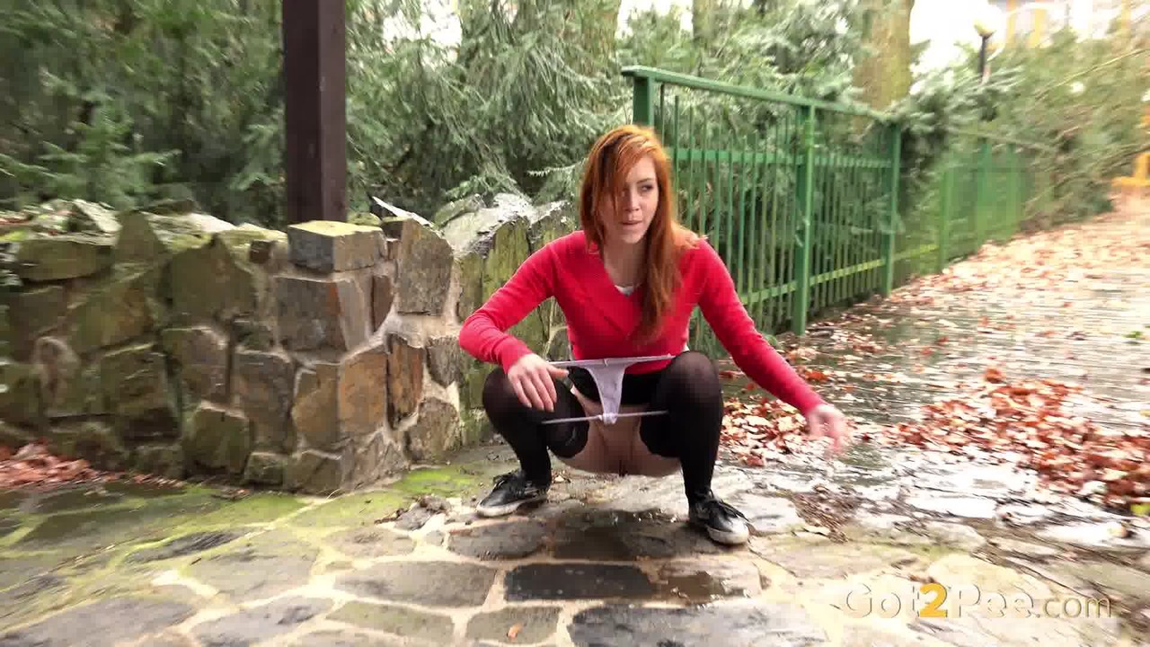 Redhead Sandra lifts her skirt to take a long hot pee in public foto porno #428736393