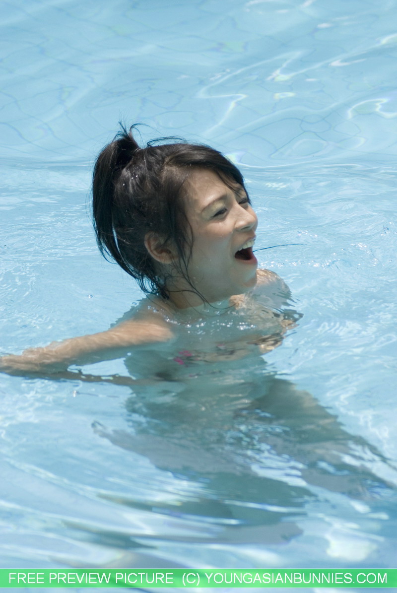 Spa swum: This young Asian girl slips into the pool after covering her naked body with some amount of sunscreen.