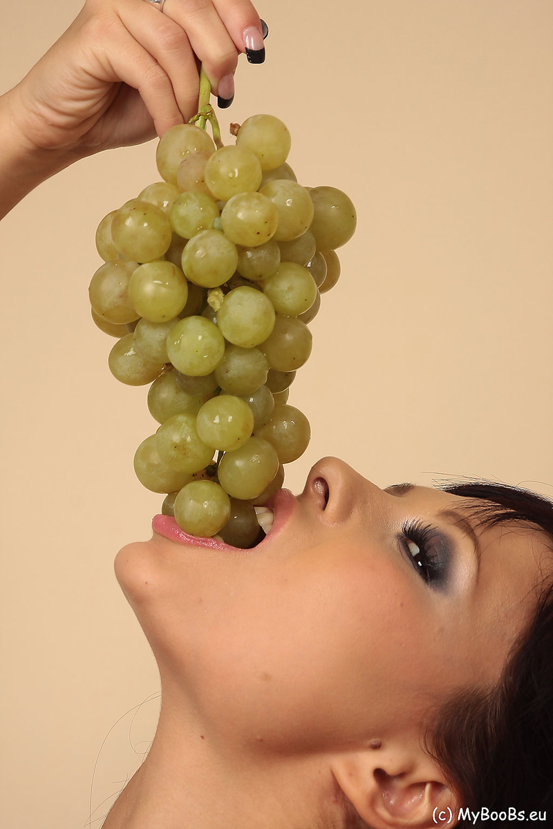 Hot brunette Domino munches on a grape bunch while removing her clothes foto porno #426364906