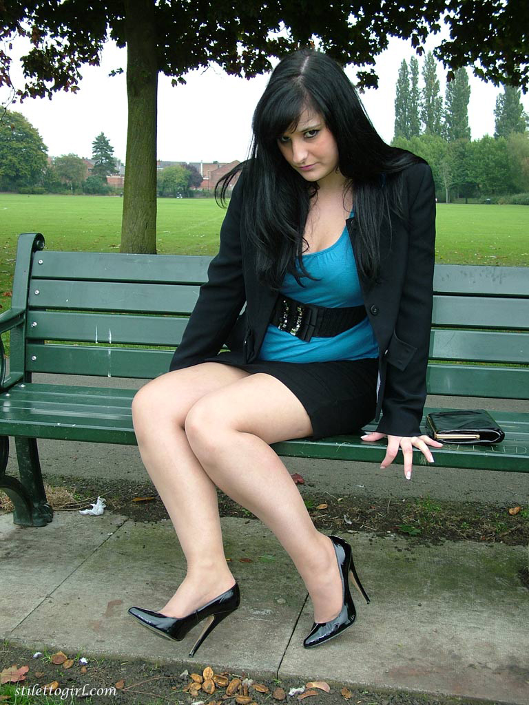 Fully clothed female dangles her stiletto heels from hose clad feet on a bench porn photo #427764092