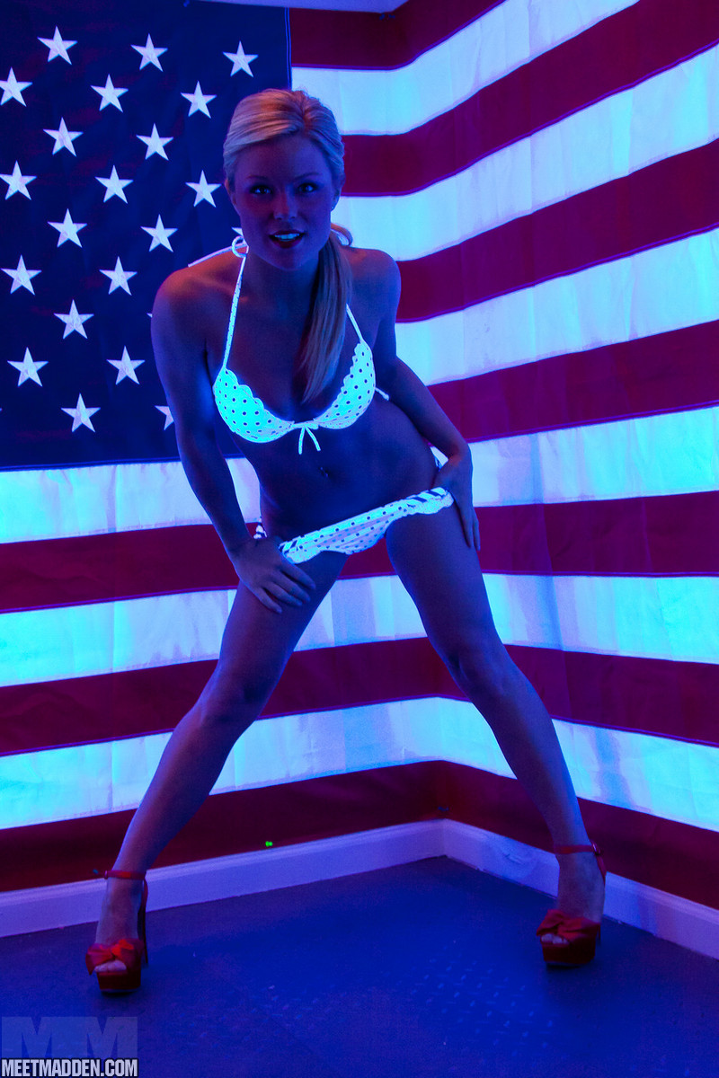 During SFW action, Meet Madden removes her bikini top.
