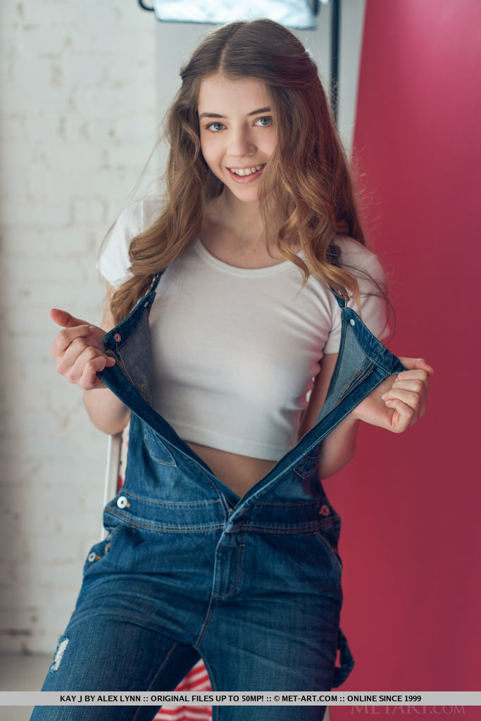 Cute teen Kay J drops her overalls and strips naked to show close up pussy porn photo #424334384