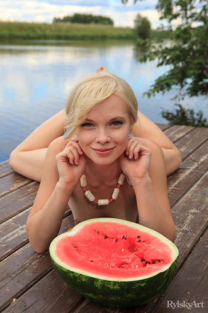 Beautiful blonde Feeona eats a watermelon while posing naked on lakeside dock porno fotoğrafı #424980746