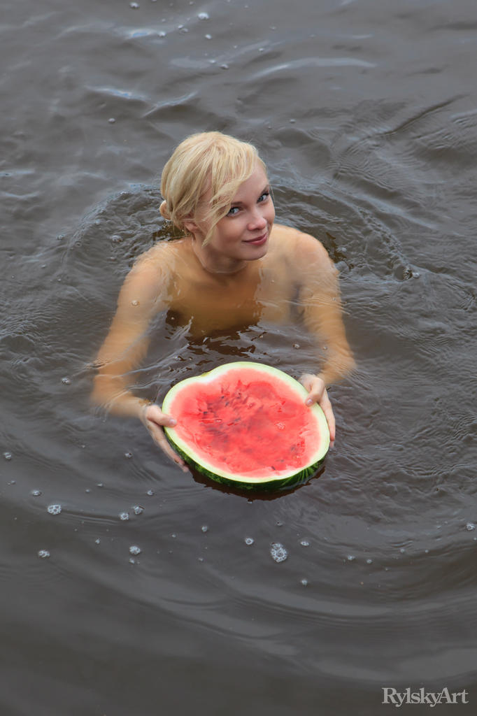 Beautiful blonde Feeona eats a watermelon while posing naked on lakeside dock foto porno #424980749