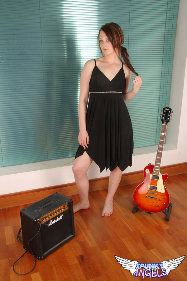 Young redhead Teagan picks up an electric guitar after getting totally naked porn photo #425476552