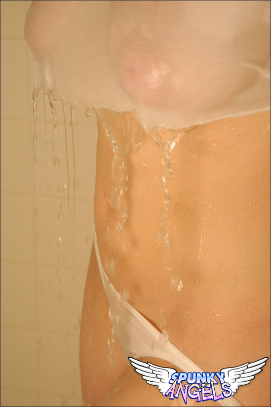 Cute teen girl takes a shower with her see thru clothes on her busty body foto porno #428191528