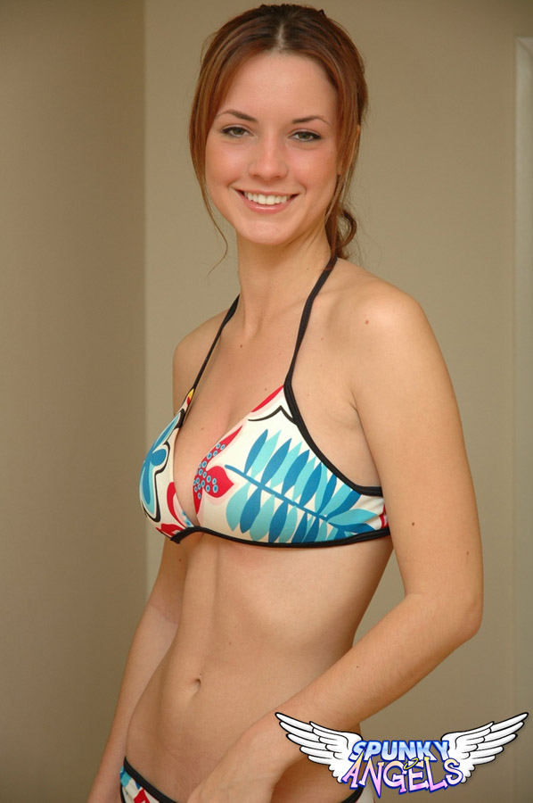 Young solo girl Amy wears a smile while posing non nude in a string bikini 