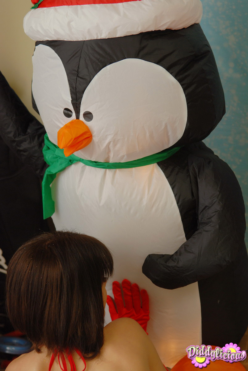 Cute girl Diddylicious kisses an inflatable penguin in a Christmas outfit foto pornográfica #425234678
