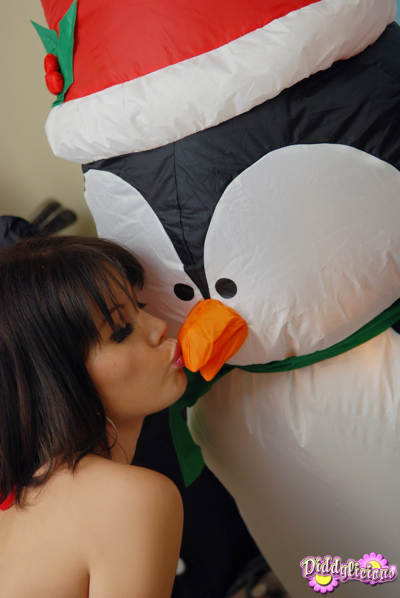 Cute girl Diddylicious kisses an inflatable penguin in a Christmas outfit foto pornográfica #425234686