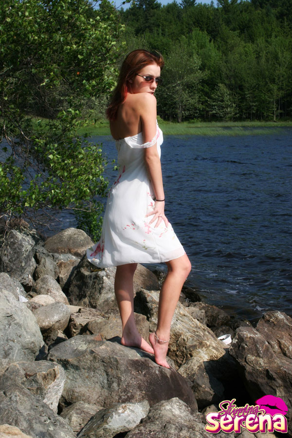 Young redhead Stunning Serena slips out of her dress on waterside rocks foto porno #428888675
