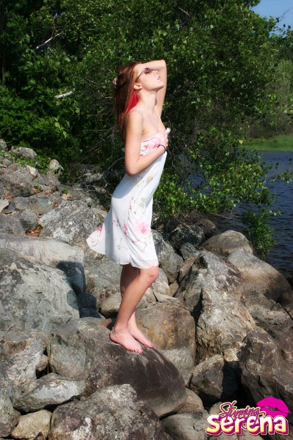 Young redhead Stunning Serena slips out of her dress on waterside rocks porn photo #428888693