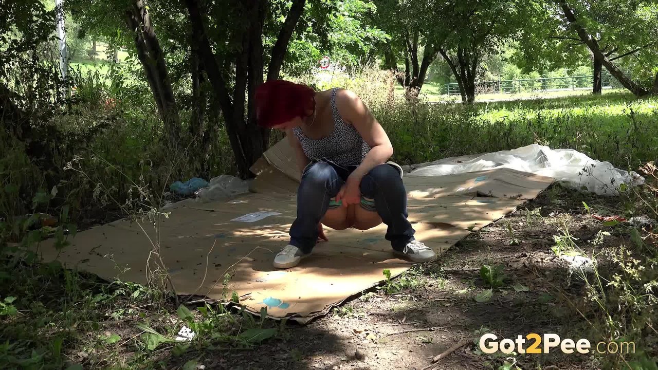Nasty redhead Sara takes a piss on a homeless person's cardboard flooring porn photo #425096244