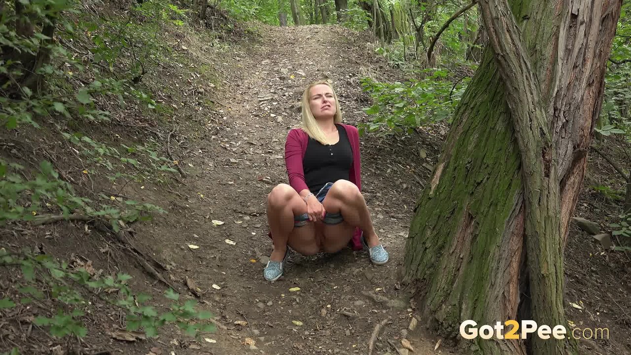 Pretty blonde Debora squats for a bald twat pee on the path in the woods foto porno #426377952
