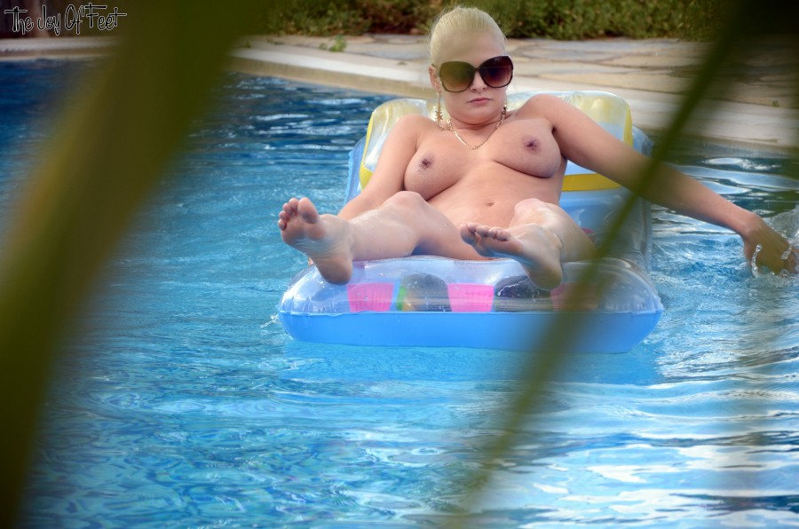 Natural Blonde Kelly Fox Lays On An Air Mattress Wearing Sunglasses Only