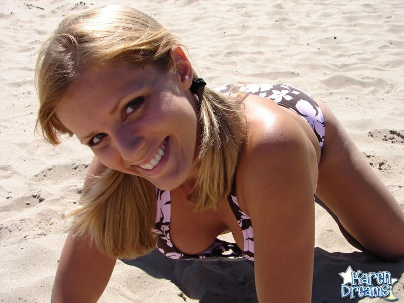 Blonde teen Karen models a bikini while on a patch of sand