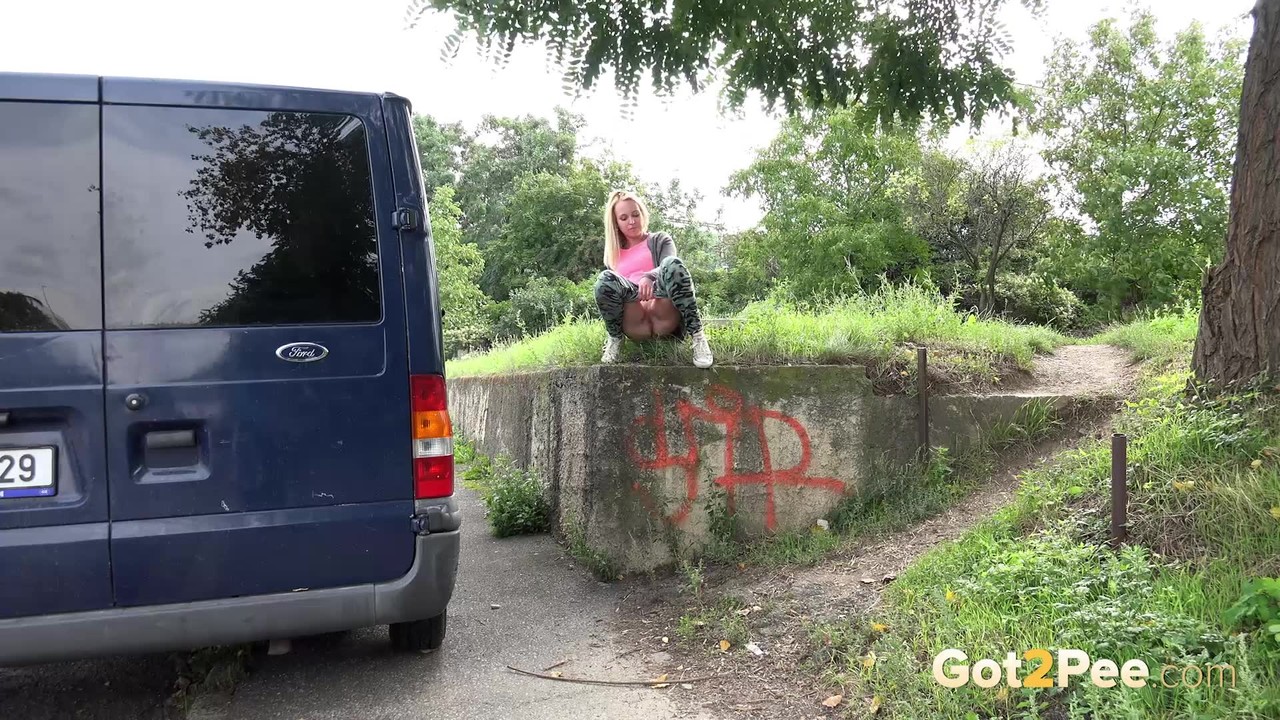 Blonde chick Debora takes piss over the side of a retaining wall by a sidewalk porn photo #426336013