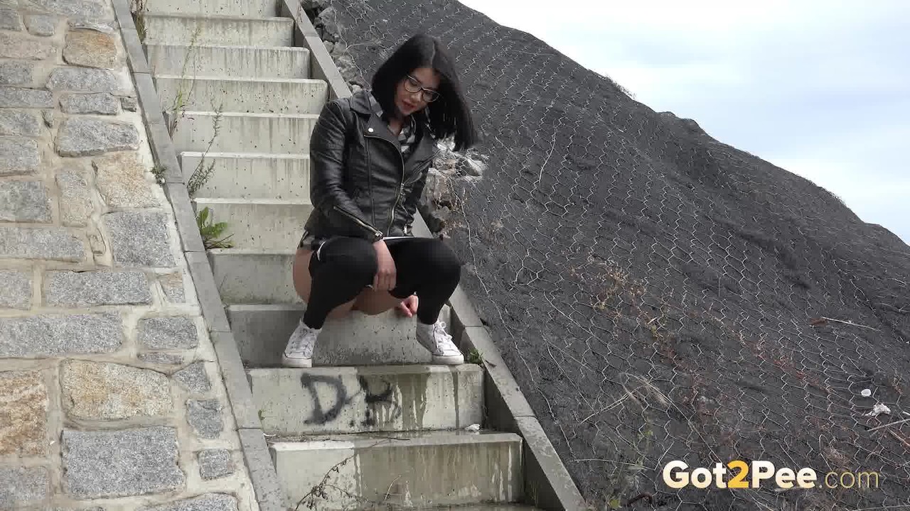 Dark haired girl Dee pulls down her leggings for a pee on concrete stairs porn photo #428726549