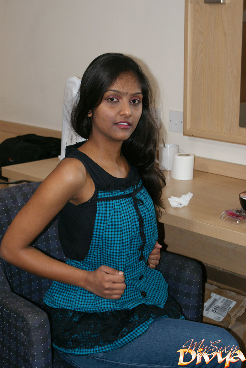 Indian amateur Divya flashes her natural breasts while sitting on a chair porn photo #428350539