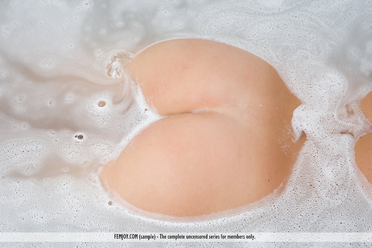 A dirty blonde model named Gina demonstrates her nice buttocks as she enters a bathtub.
