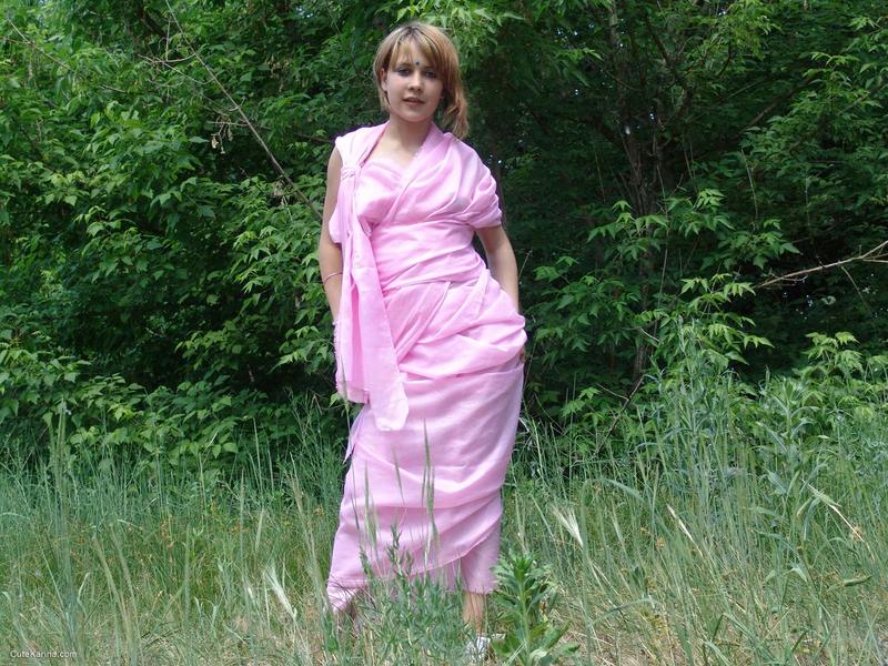 Teenage explorer Liza goes for first time: She is seen getting naked in the field, right in front of a tree line (far left).