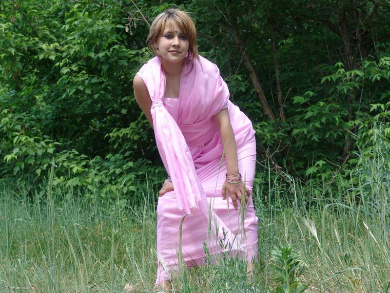 Teen first timer Liza gets naked in a field in front of a tree line