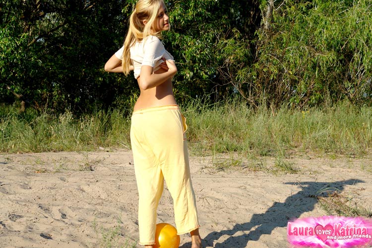As she exposes her clothes outside, the young blonde reveals all her firm breasts.