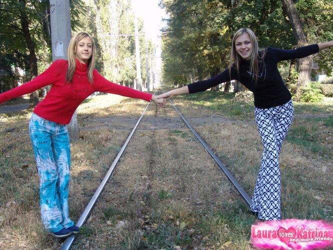 Teen lesbians Laura & Katrina flash their tits and butts while wandering about