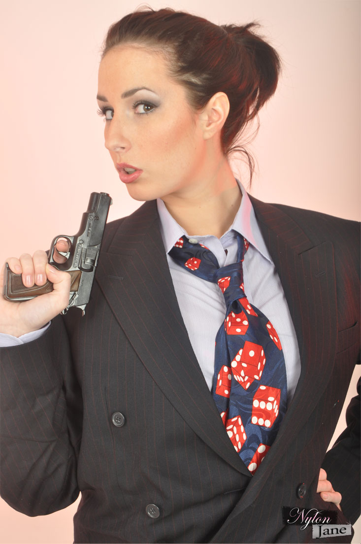 Clothed solo model Paige Turnah struts in a blazer while waving a pistol porn photo #425645112