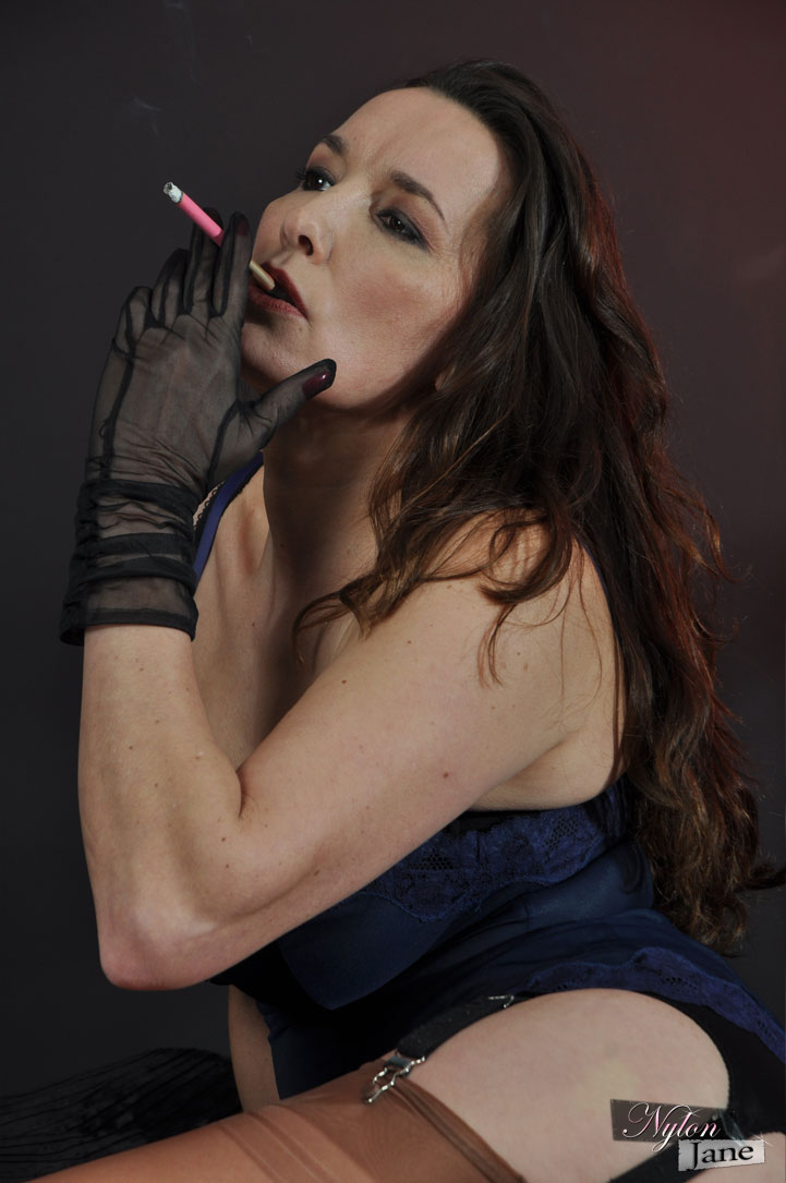 Mature woman Nylon Jane smokes while wearing sheer gloves and tan nylons porn photo #426611631
