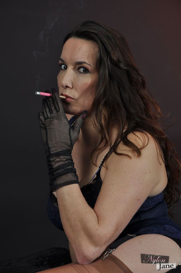 Mature woman Nylon Jane smokes while wearing sheer gloves and tan nylons foto porno #426611633