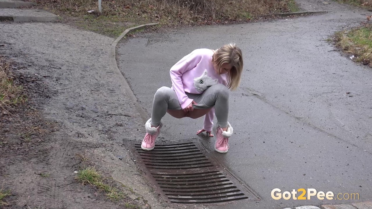 Blonde chick Claudia Macc takes an urgent piss over a storm drain porn photo #426382235