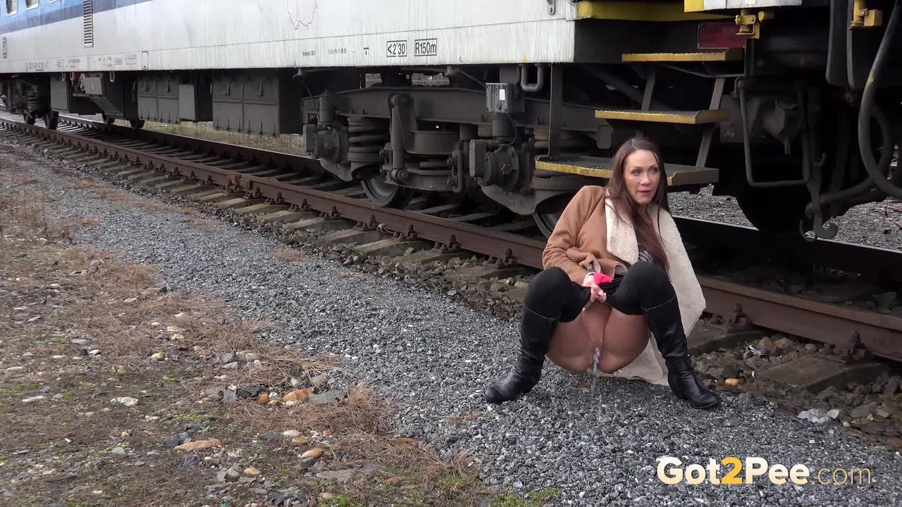 Cynthia Vellons pulls down black tights for a quick piss near railway cars porn photo #425615919