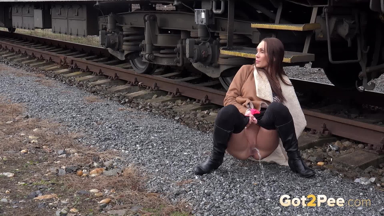 Cynthia Vellons pulls down black tights for a quick piss near railway cars porn photo #425615921