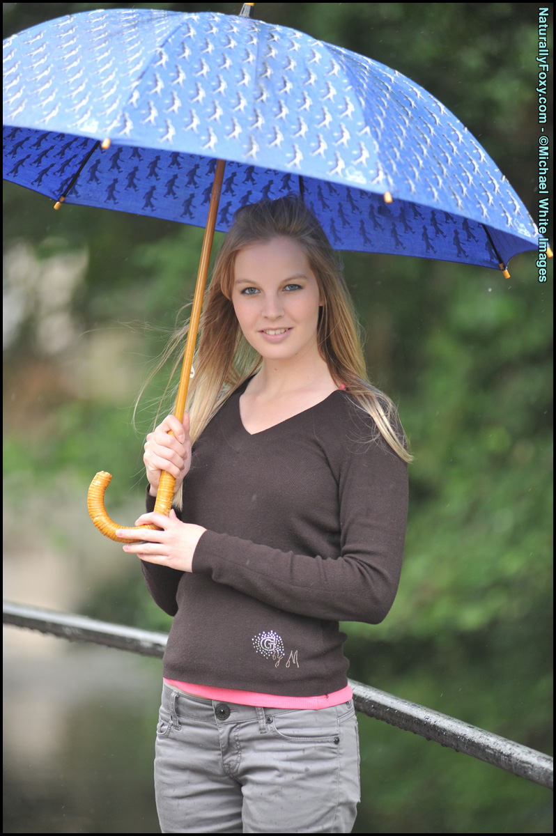 Blonde girl next-door type holds an umbrella while getting bare naked foto porno #429068577