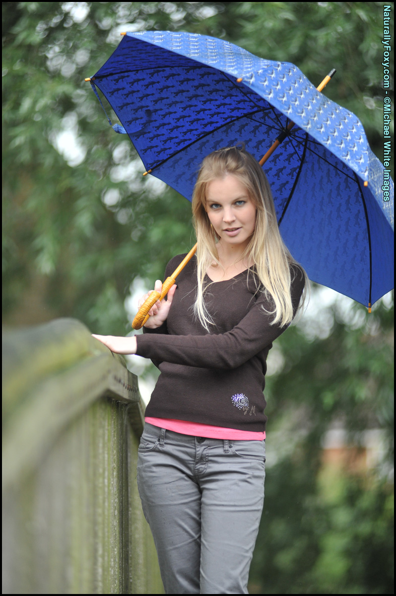 Blonde girl next-door type holds an umbrella while getting bare naked foto porno #429068578