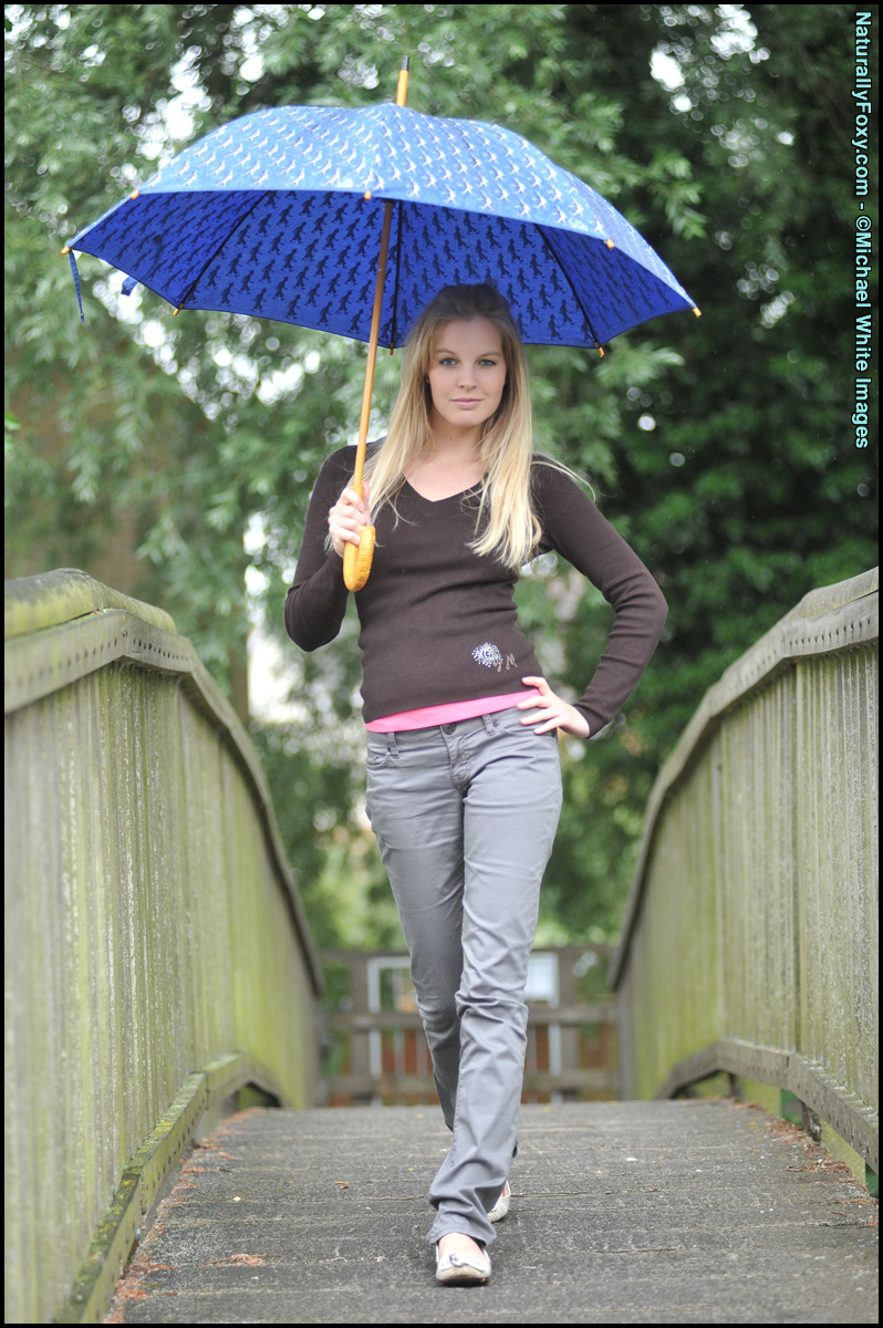 Blonde girl next-door type holds an umbrella while getting bare naked foto porno #429068579
