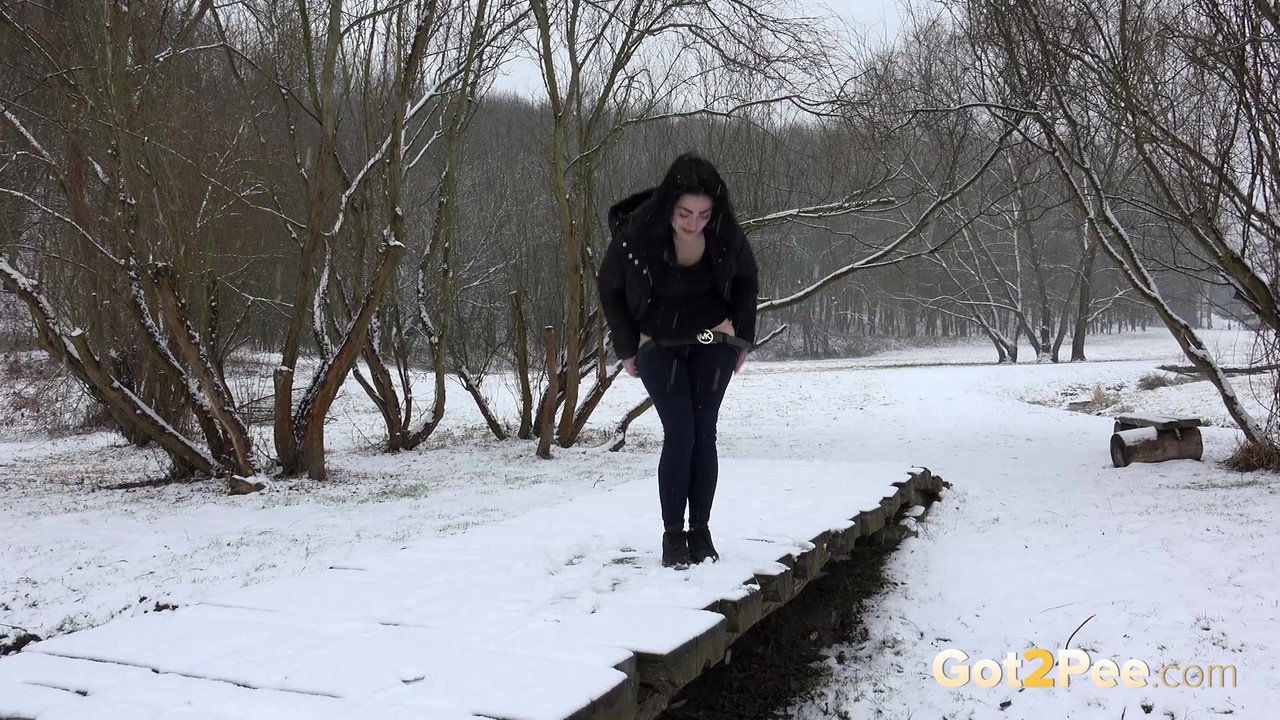 Dark haired girl pees on a bridge in the snow foto porno #425143685