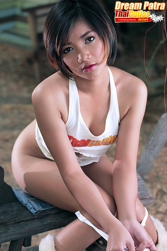 Petite Thai cutie Dream Patra undresses on a wooden bench in a yard foto porno #426651489