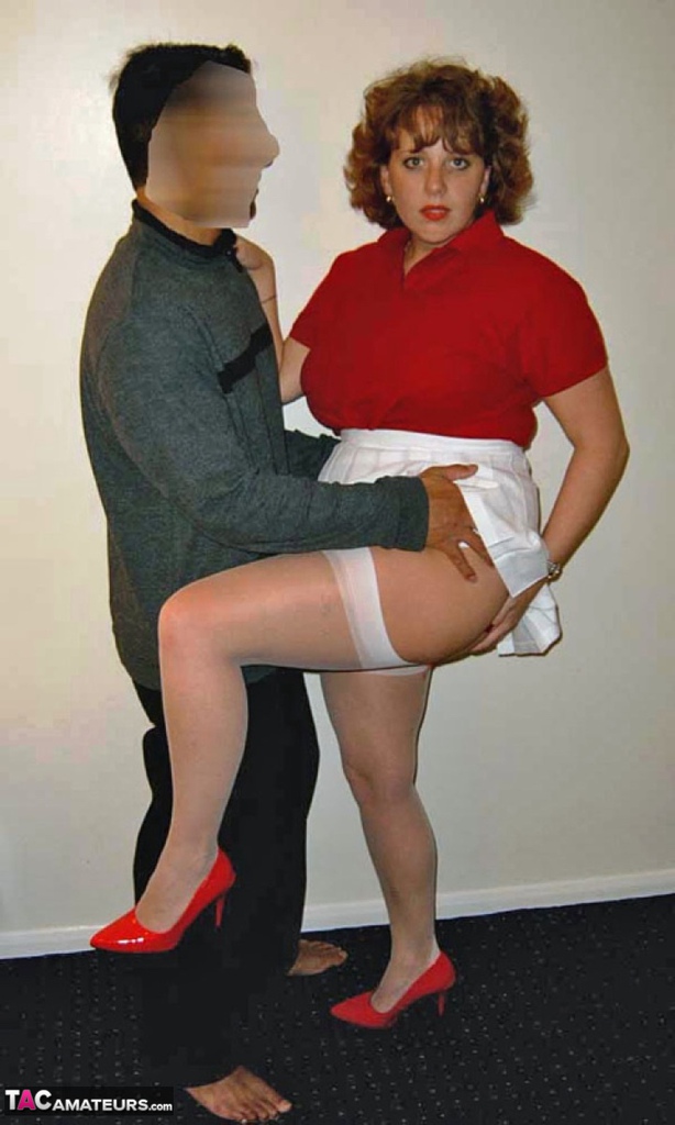 Curvy, an older woman of two ages and a redhead, shares oral sex with her lover on a bed.