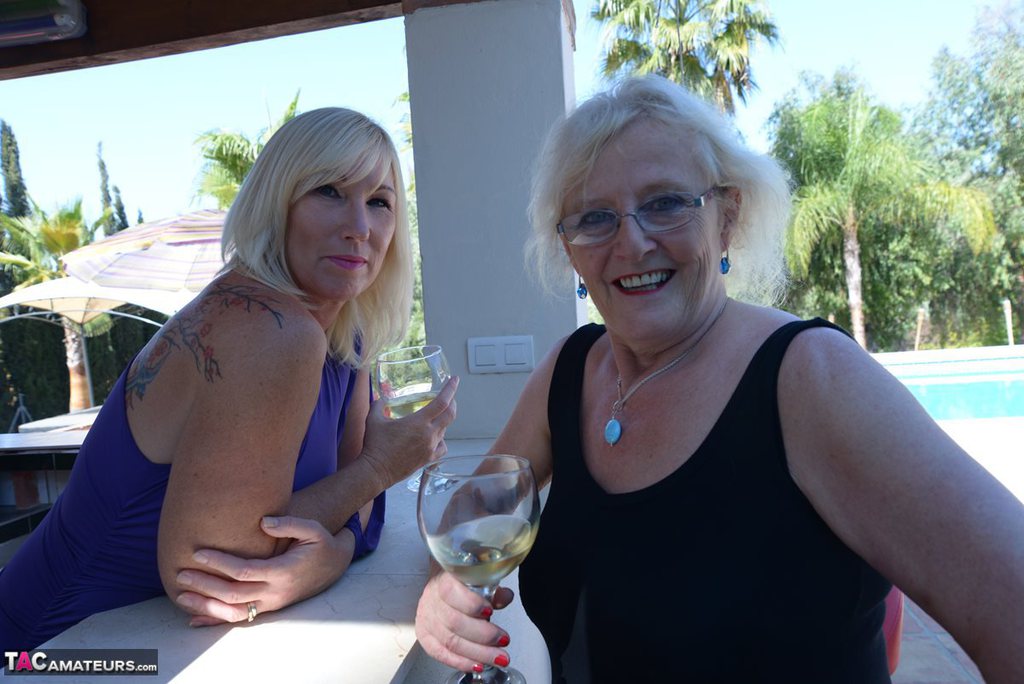 Old women share a lesbian kiss after drinking to much wine out on the patio porn photo #425918830