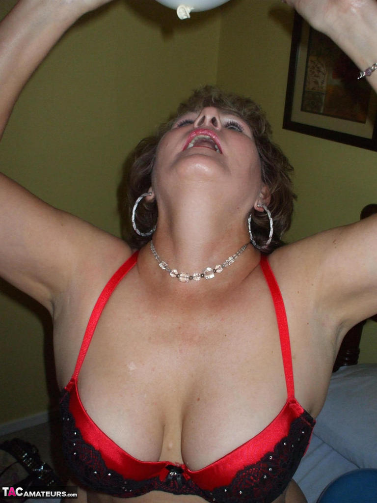 Older lady Busty Bliss plays with balloons before uncupping her natural tits photo porno #426430140