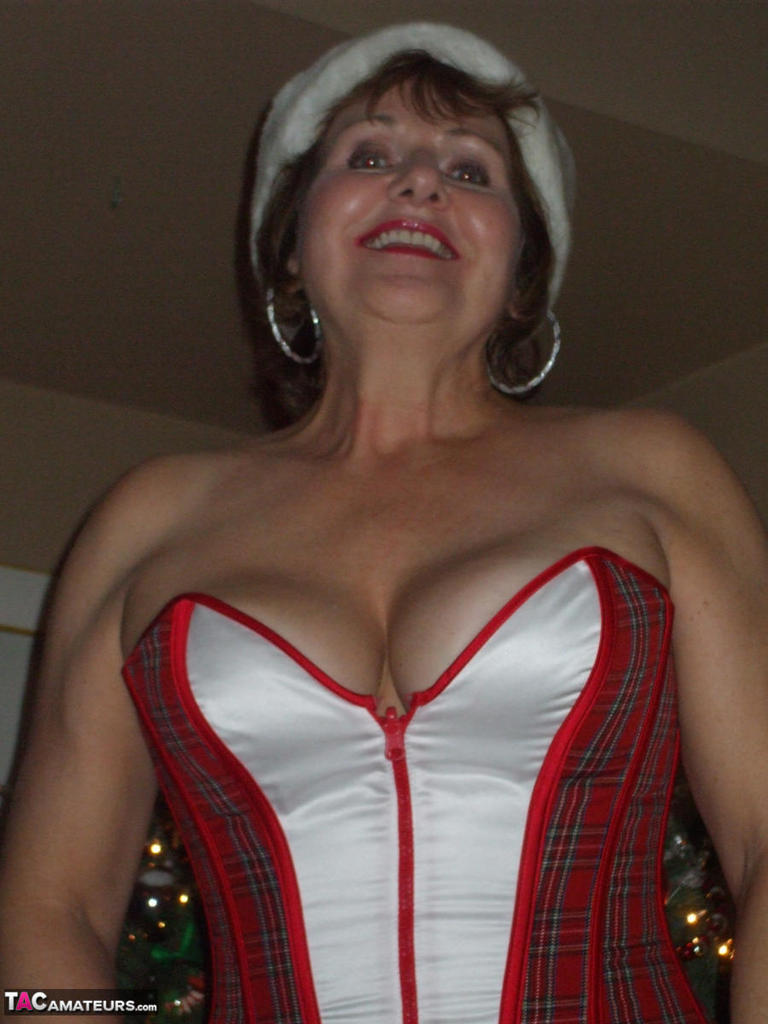 Adult adult Busty Bliss shows off her thong-covered buttocks during Christmas.